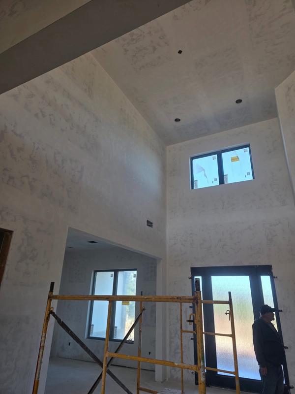 Two story entry with scaffold, drywall taped and floated