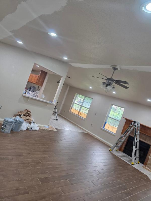 Remodeled living room with new plank flooring and fresh paint