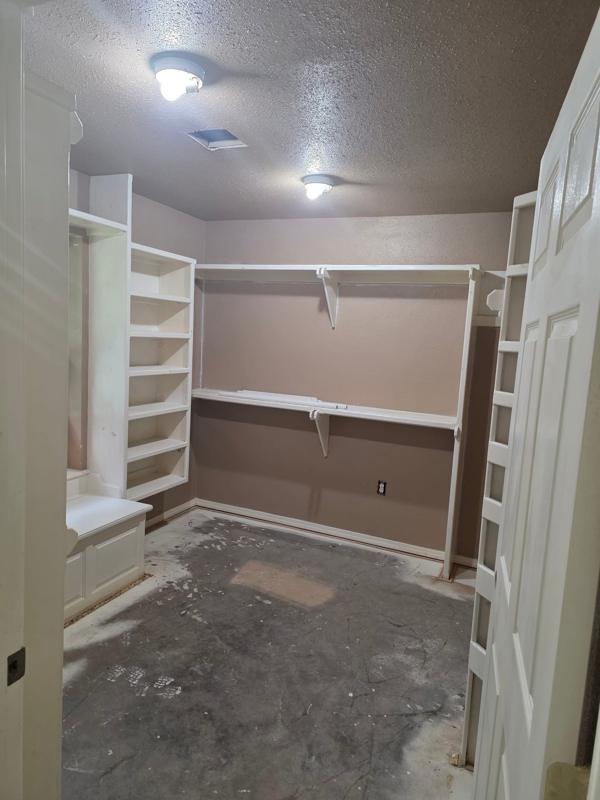 Closet repainted with shelving reinstalled